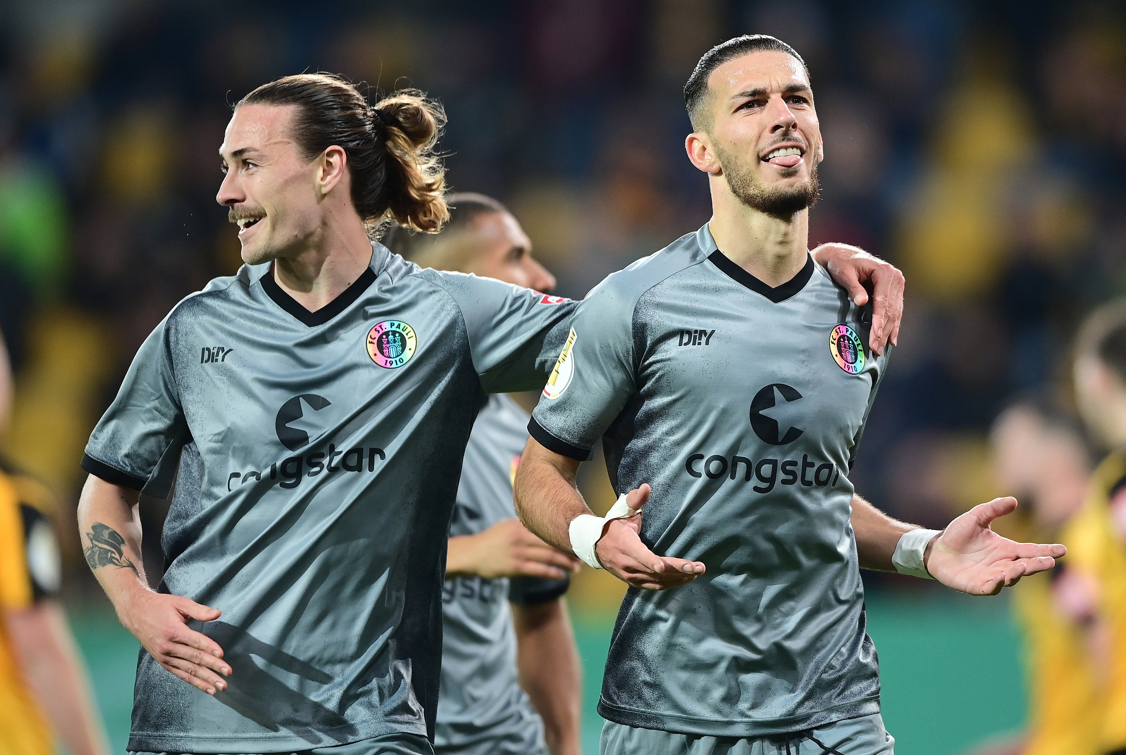 The start of ten crazy minutes: Leart Paqarada celebrates his opening goal with Jackson Irvine on 63.