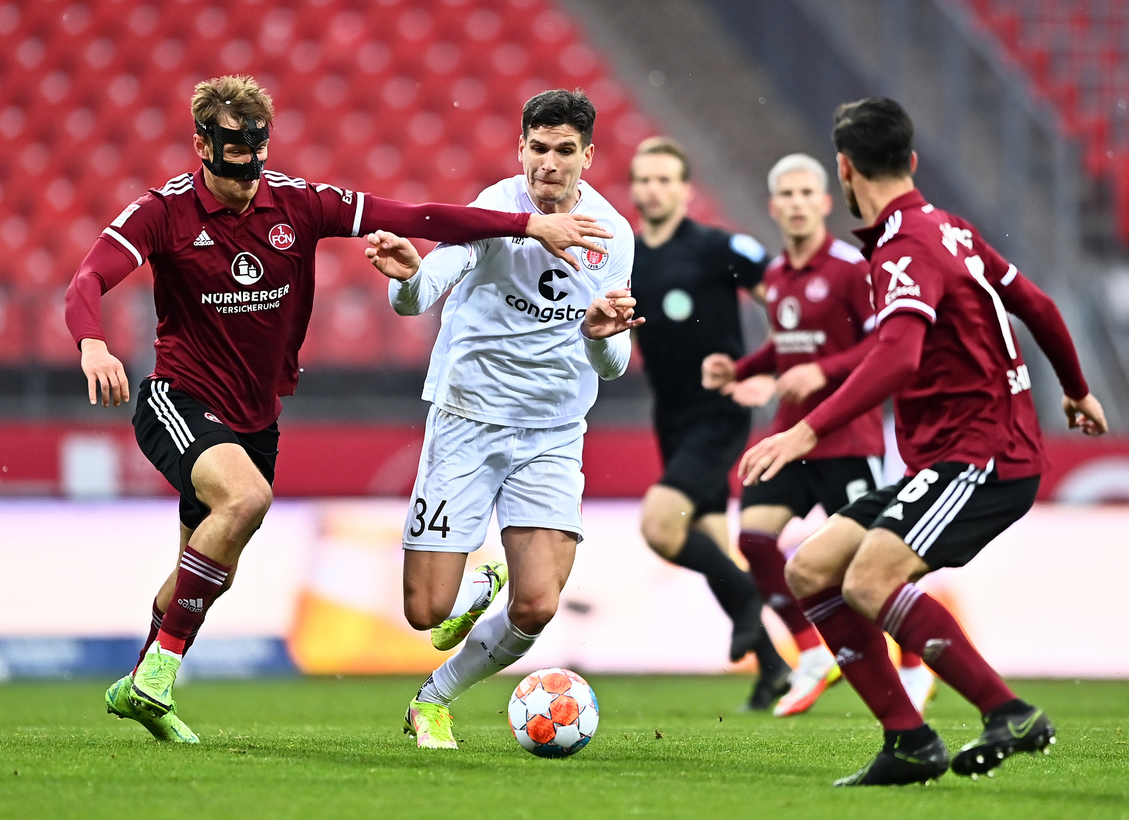 Igor Matanović under challenge from Nürnberg's Asger Sörensen (left) and Christopher Schindler.