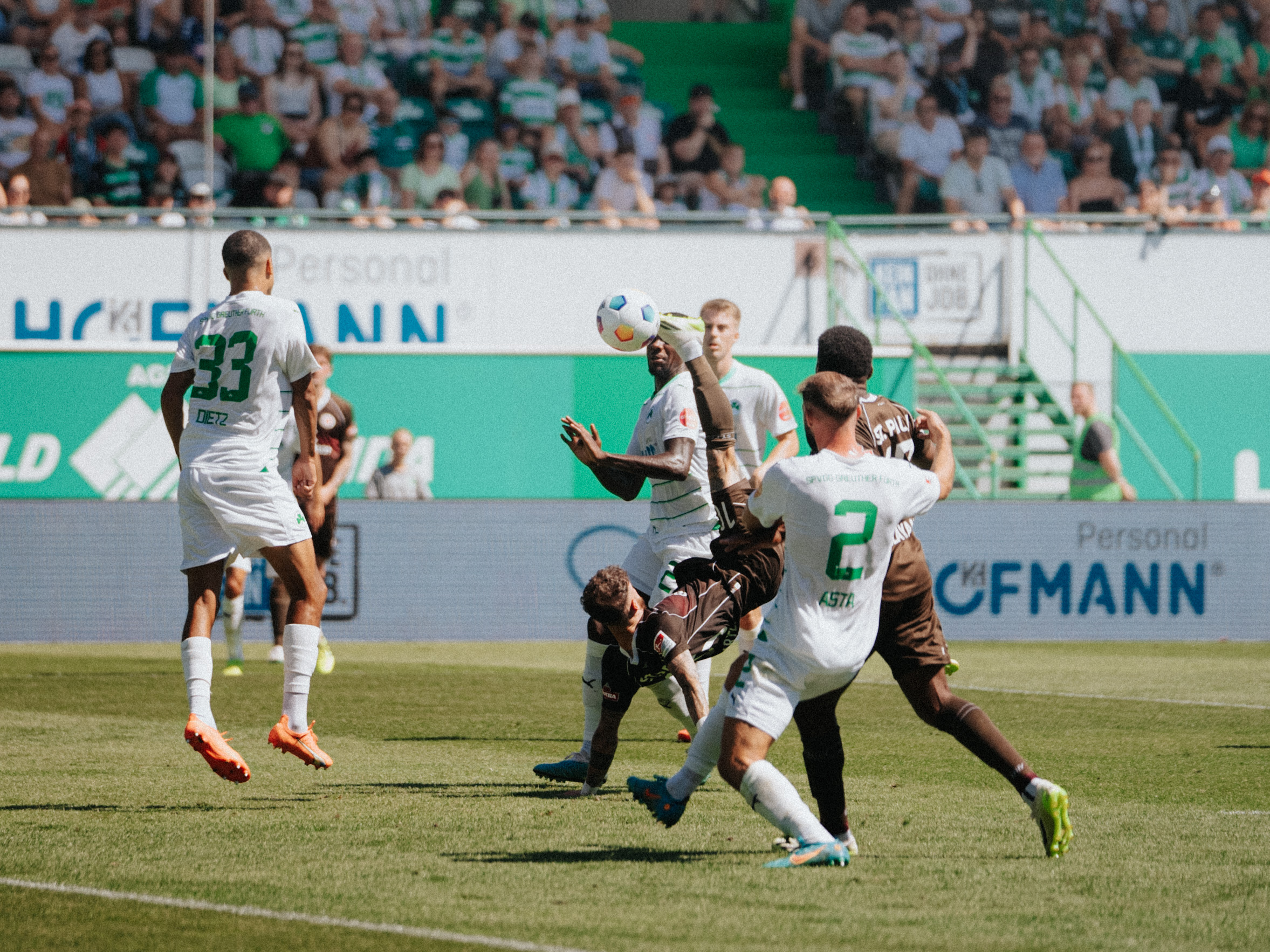 Marcel Hartel attempts an acrobatic overhead kick but narrowly fails to make contact.