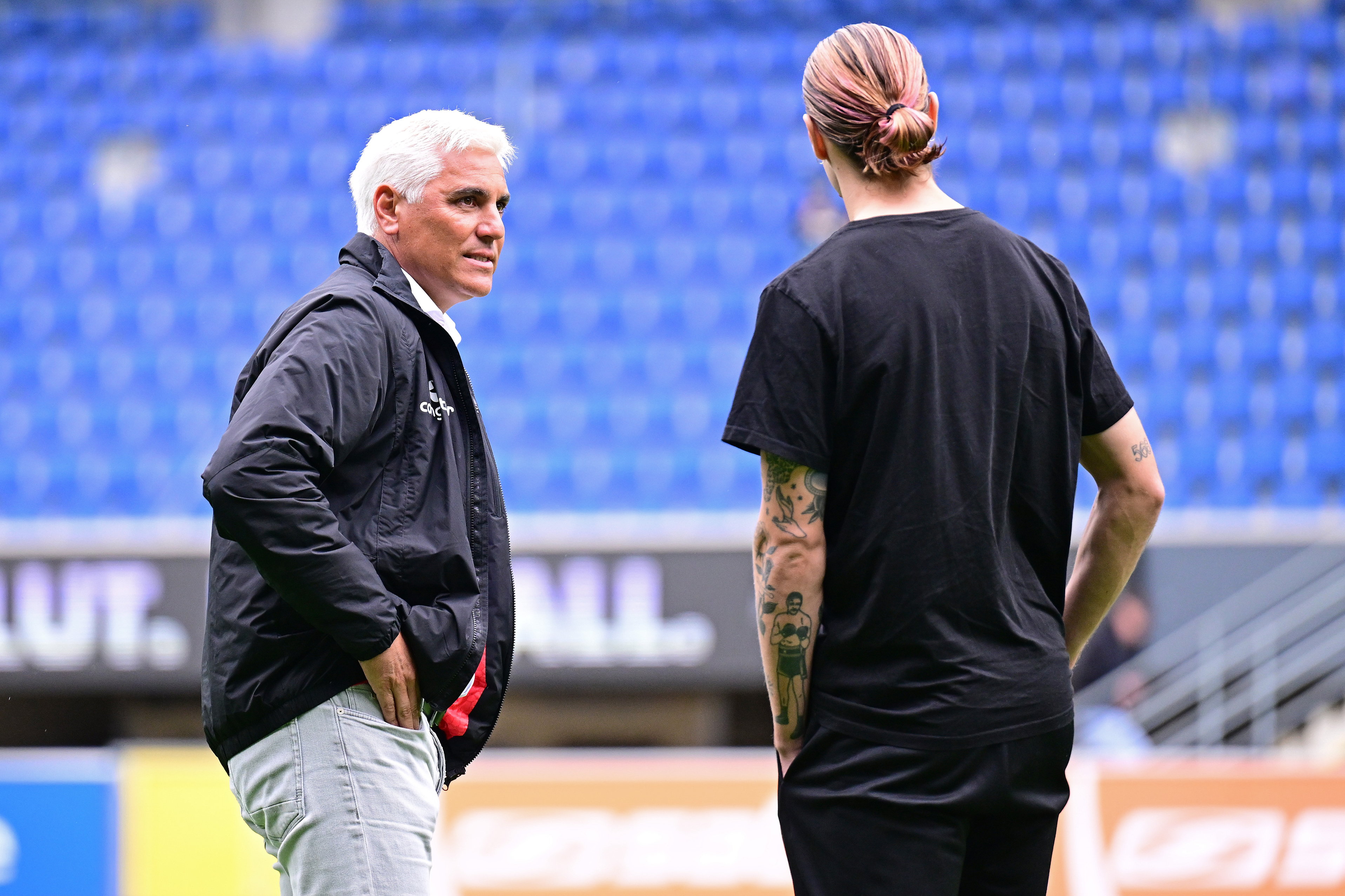 Director of sport Andreas Bornemann in conversation with captain Jackson Irvine.