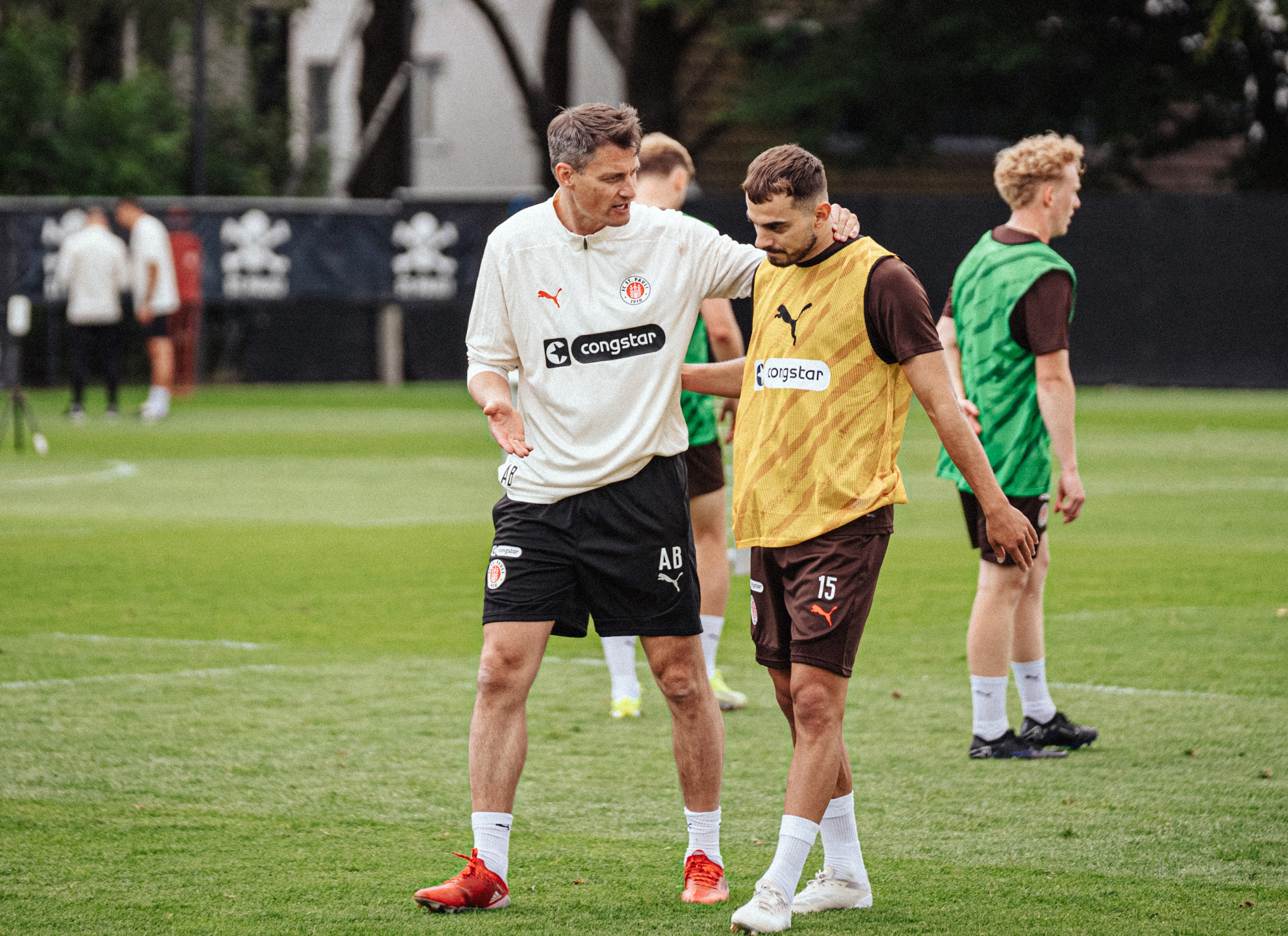 Head coach Alexander Blessin held several brief conversations on the pitch during the opening session, as here with winger Danel Sinani.