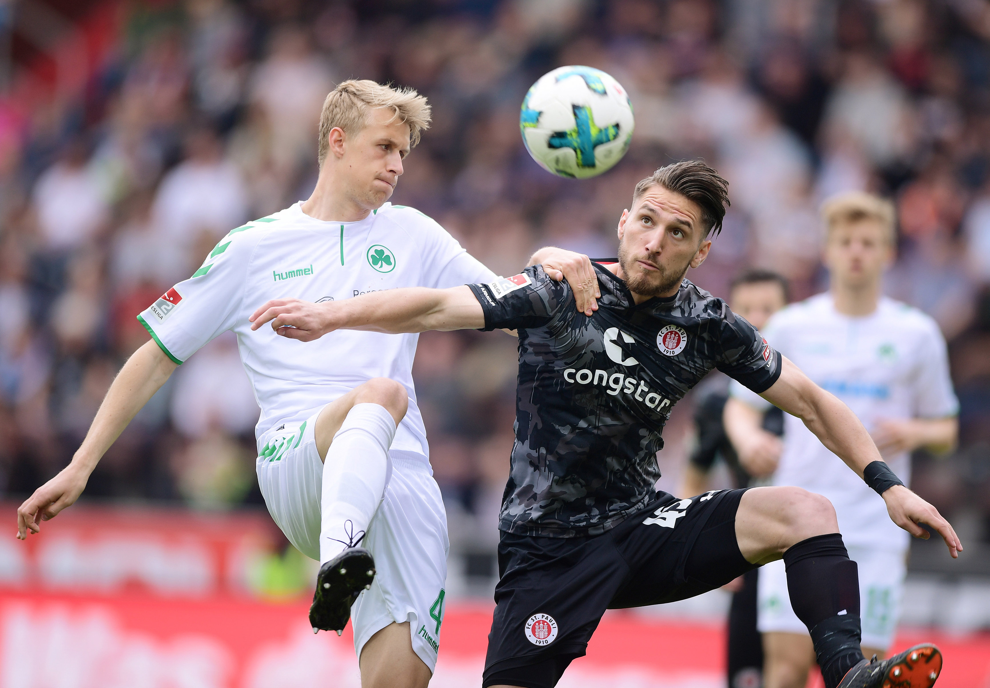 Dimitrios Diamantakos, who scored his first competitive goal for the club today, challenges for the ball with Fürth's Lukas Gugganig.