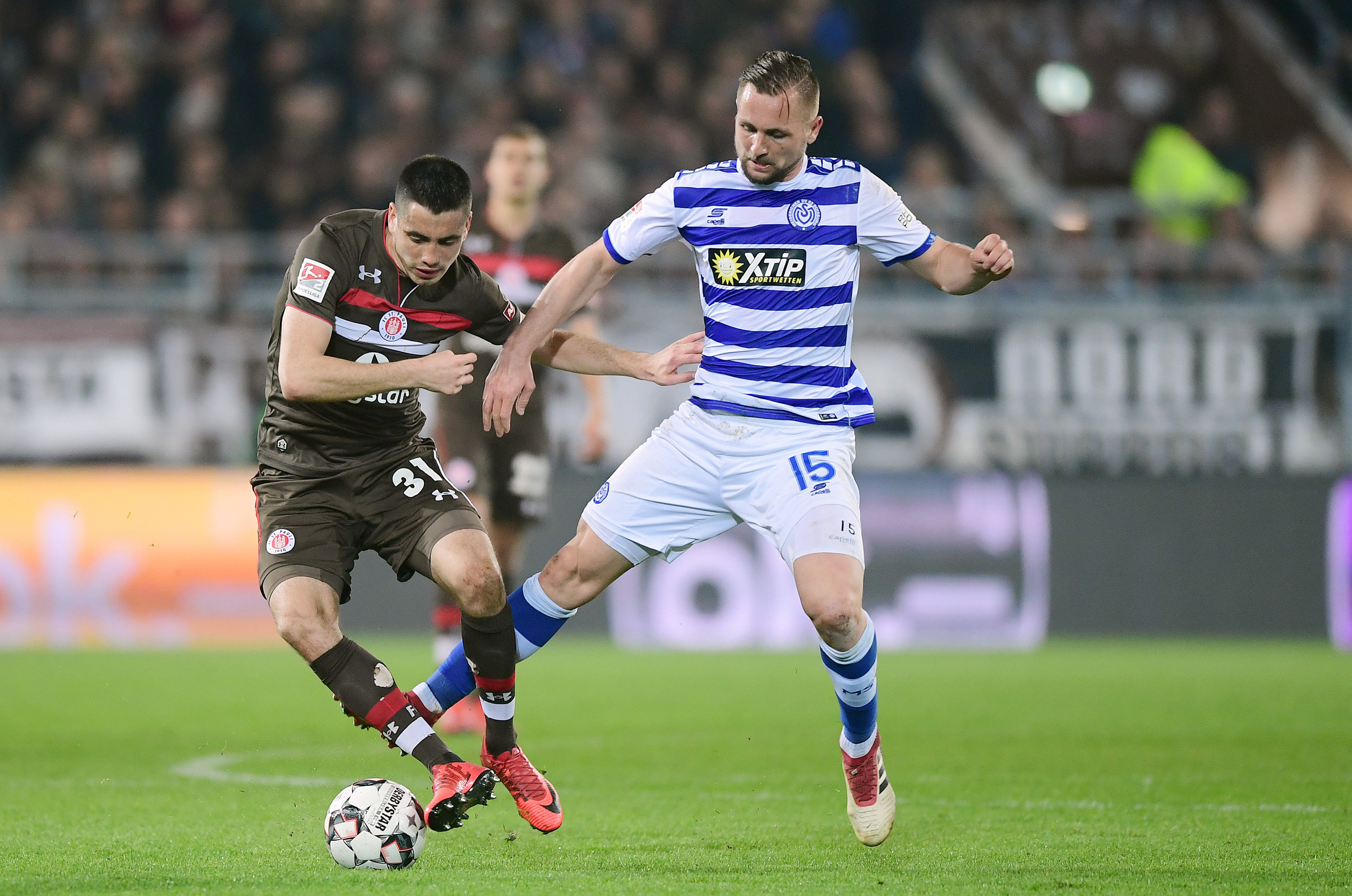 Ersin Zehir under challenge from former St. Pauli man John Verhoek.